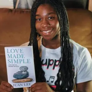 A young reader holding Love Made Simple
